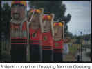 Judi peeking out from bollards carved to represent lifeguard team - 