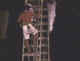 Thailand Phuket Veg Fest man climbing bladed ladder.jpg (16815 bytes)