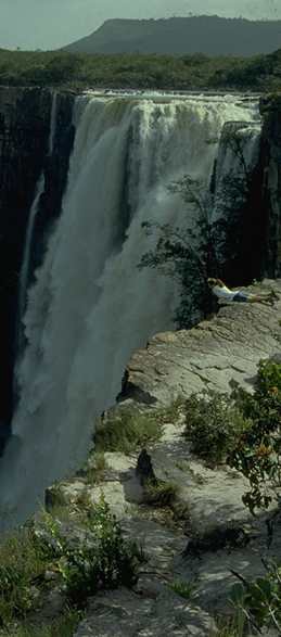 1000' waterfall leaps from edge of plateau to jungle below